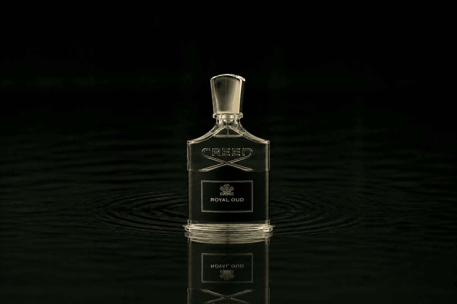 Creed Royal Oud fragrance bottle floating above dark water