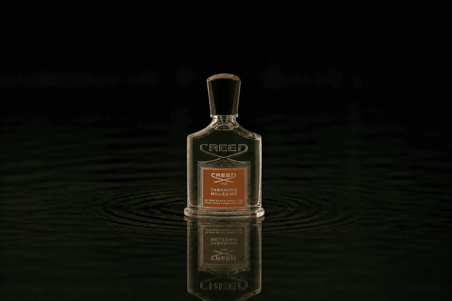 Creed Tabarome Millesime fragrance bottle floating above dark water