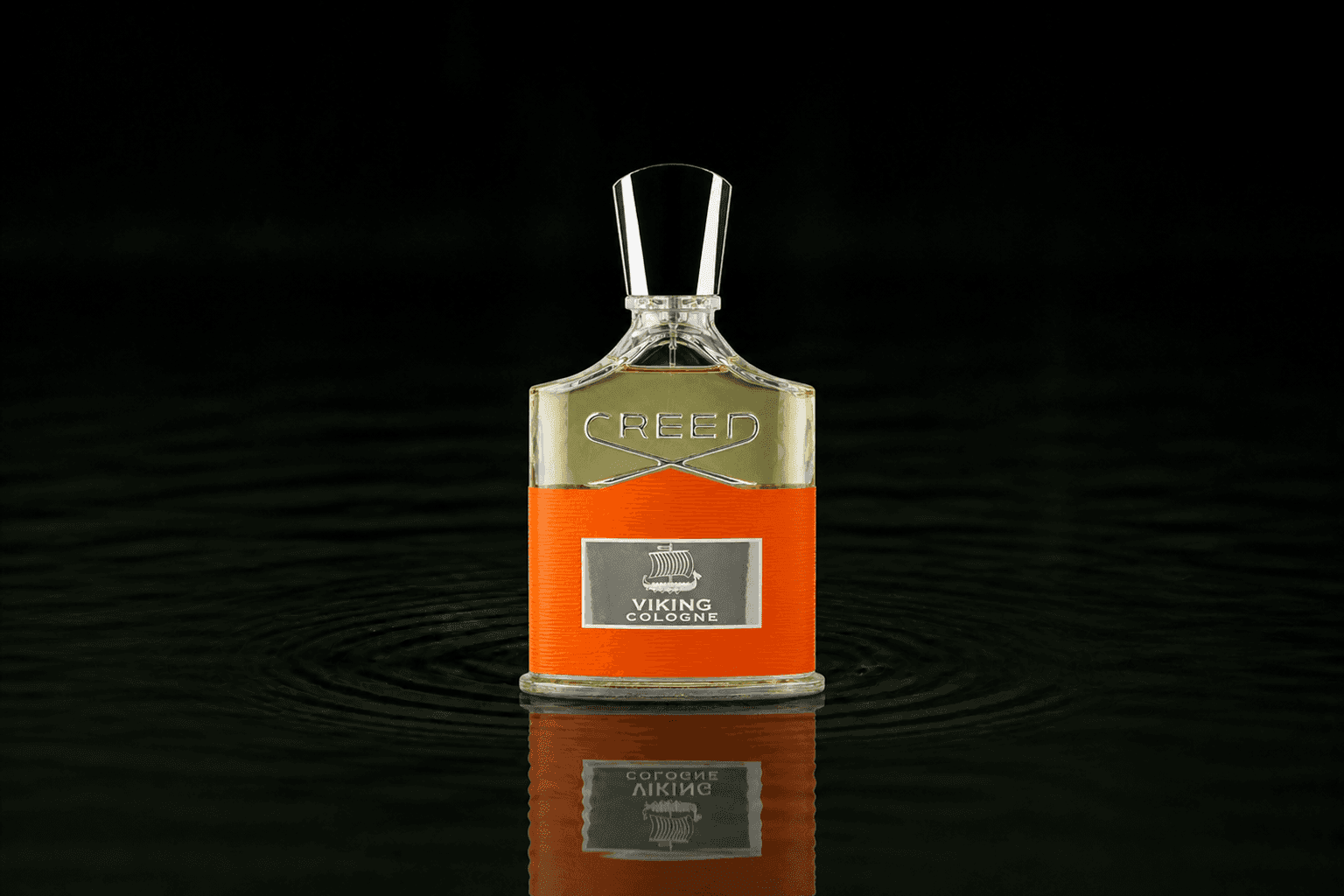 Creed Viking Cologne fragrance bottle floating above dark water