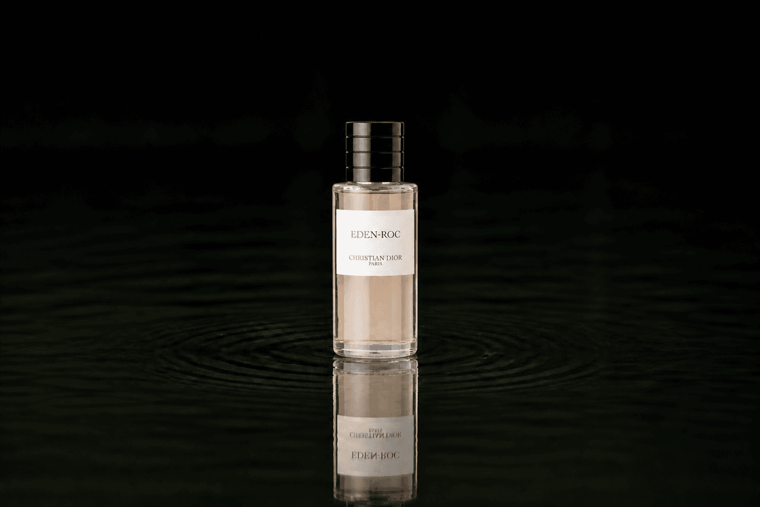 Dior Christian Dior - Eden Rock fragrance bottle floating above dark water