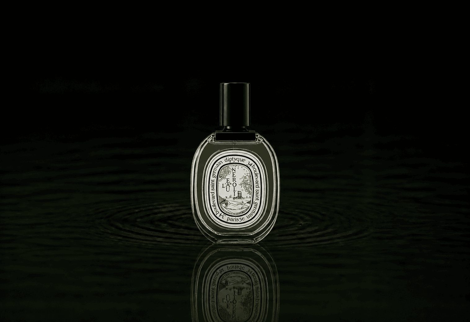 Diptyque L'Eau de Neroli fragrance bottle floating above dark water