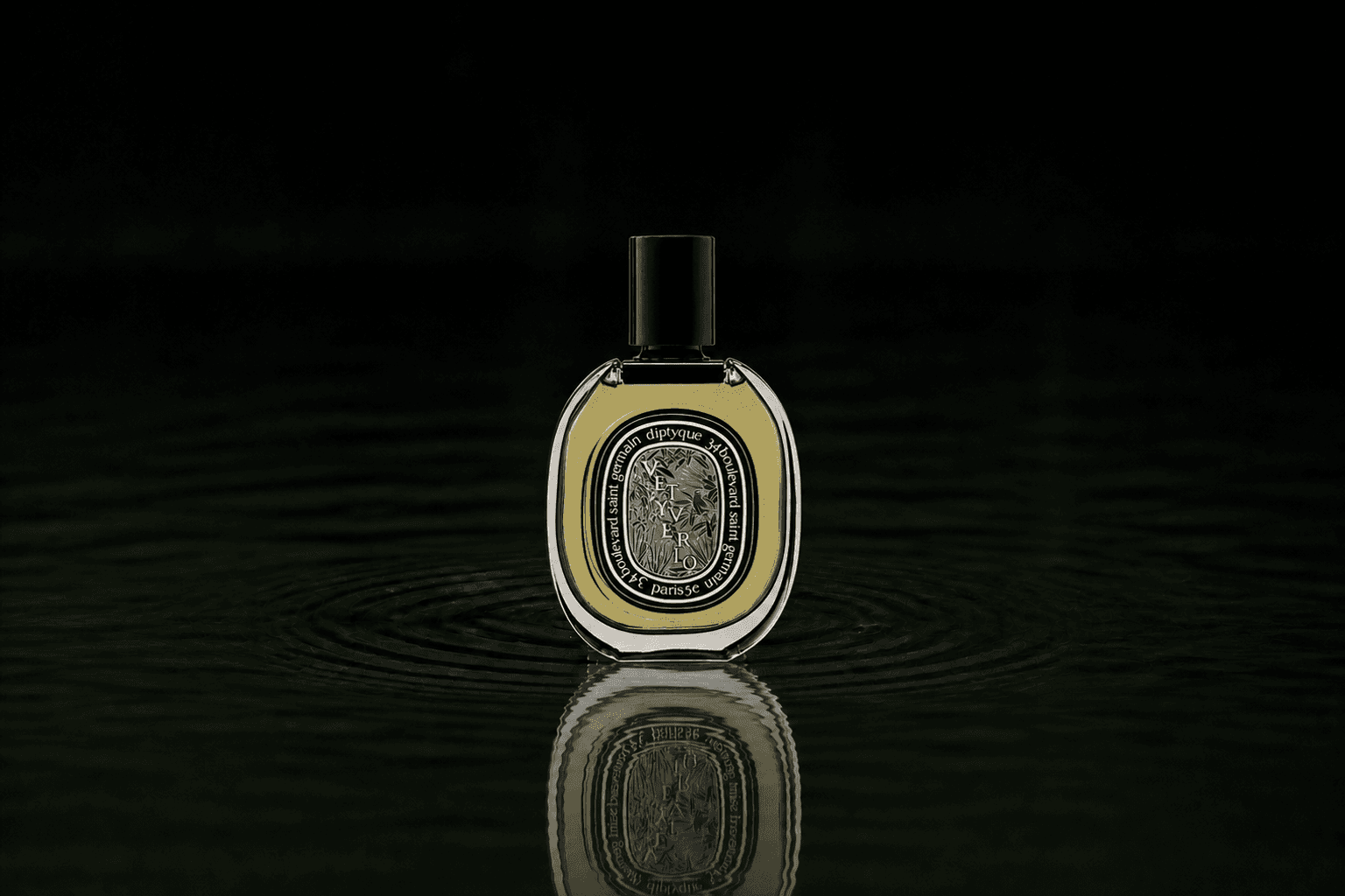 Diptyque Vetyverio fragrance bottle floating above dark water