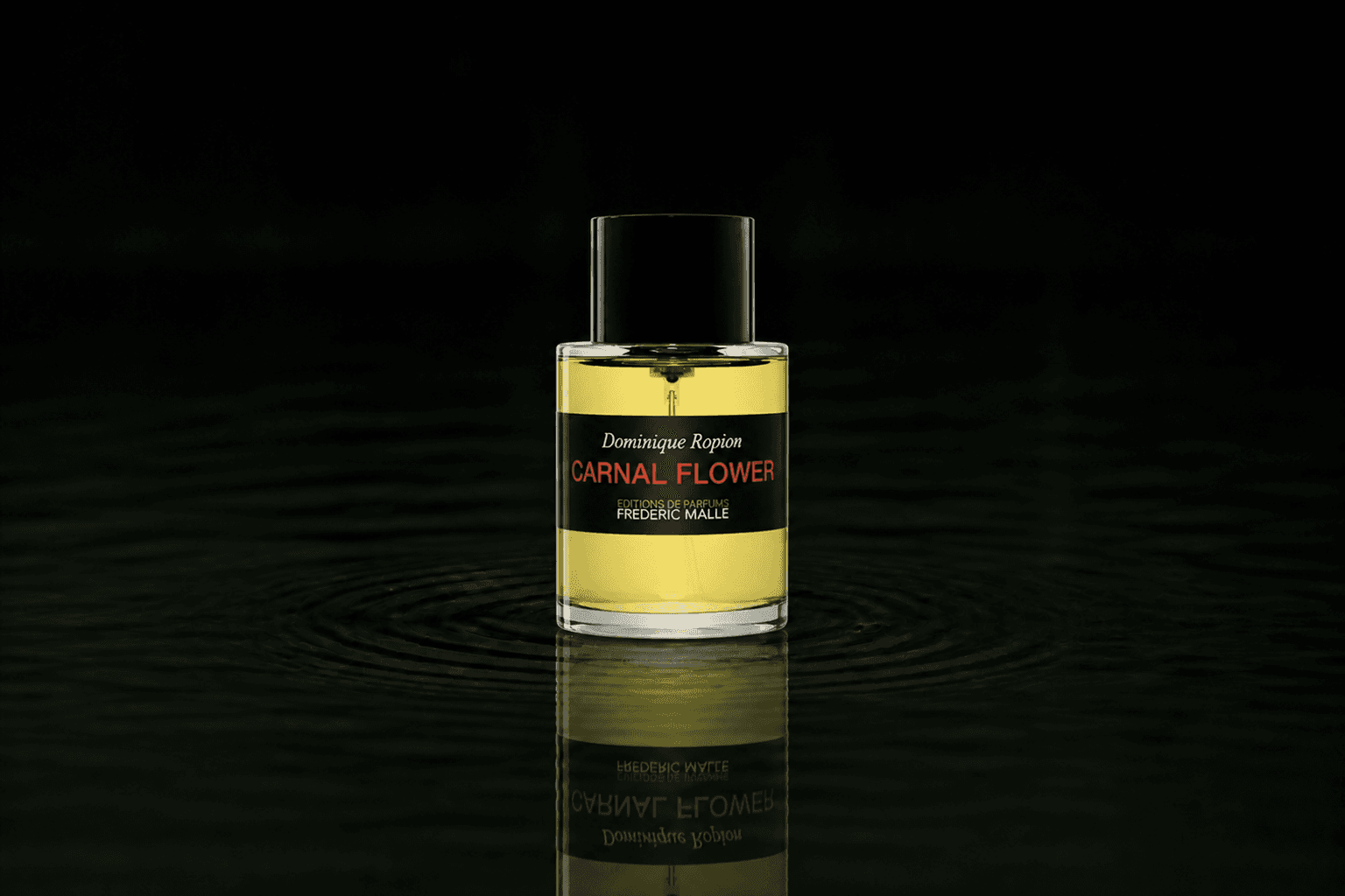 Editions de Parfums Frederic Malle Carnal Flower fragrance bottle floating above dark water