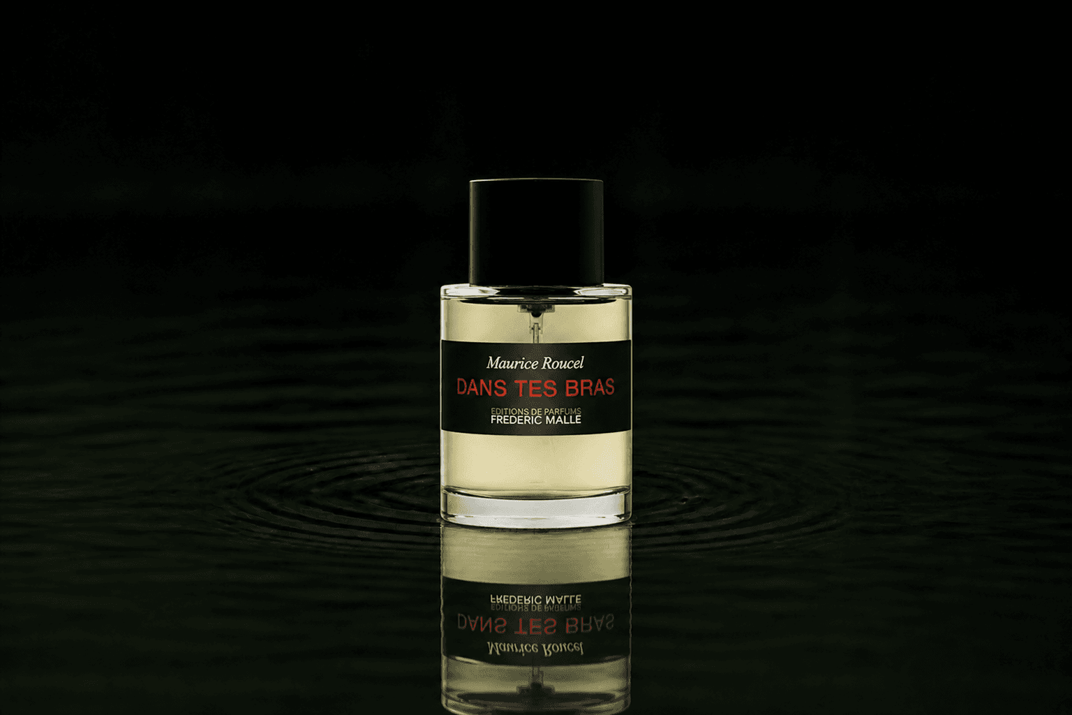 Editions de Parfums Frederic Malle Dans tes bras fragrance bottle floating above dark water