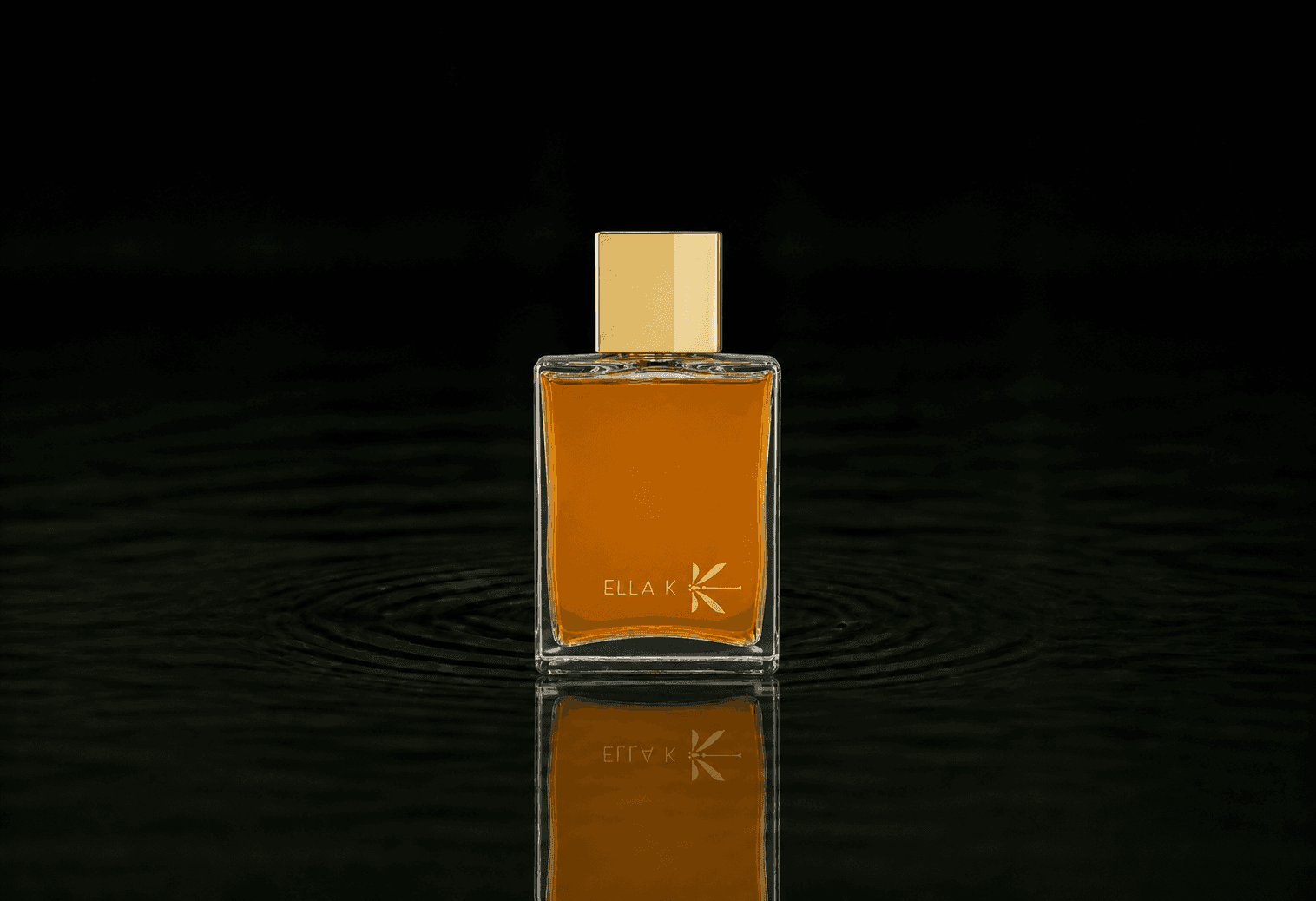 Ella K Ghibli fragrance bottle floating above dark water