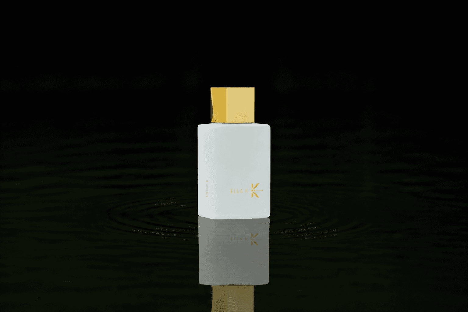Ella K Musc K fragrance bottle floating above dark water