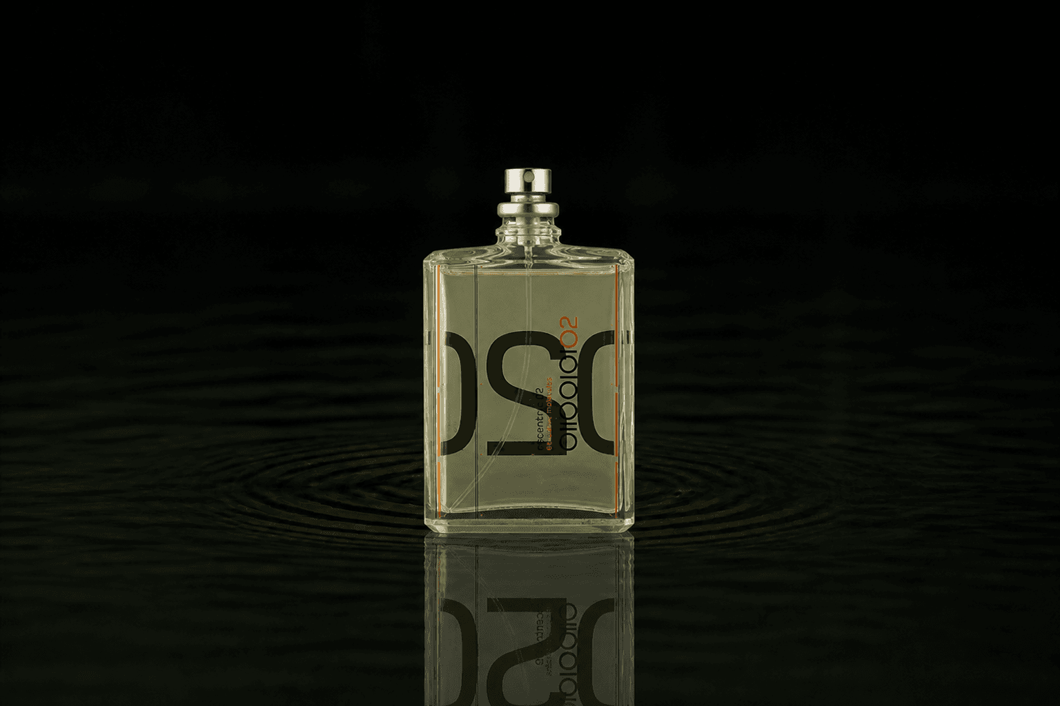 Escentric Molecules Escentric 02 fragrance bottle floating above dark water