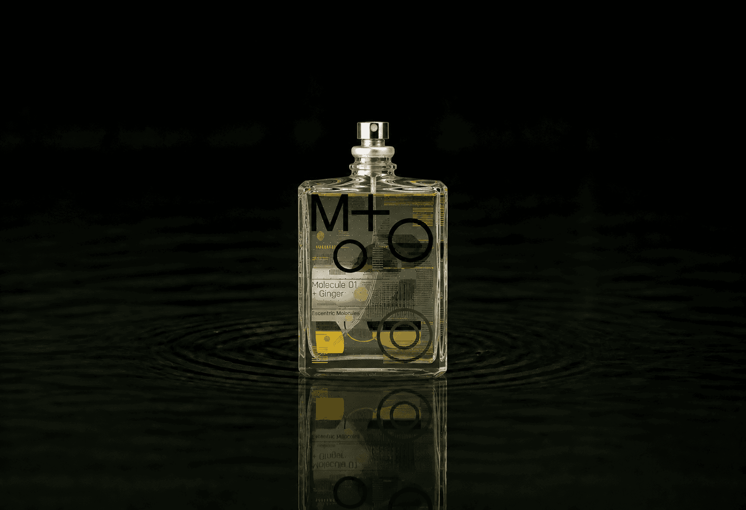 Escentric Molecules Molecule 01 + Ginger fragrance bottle floating above dark water