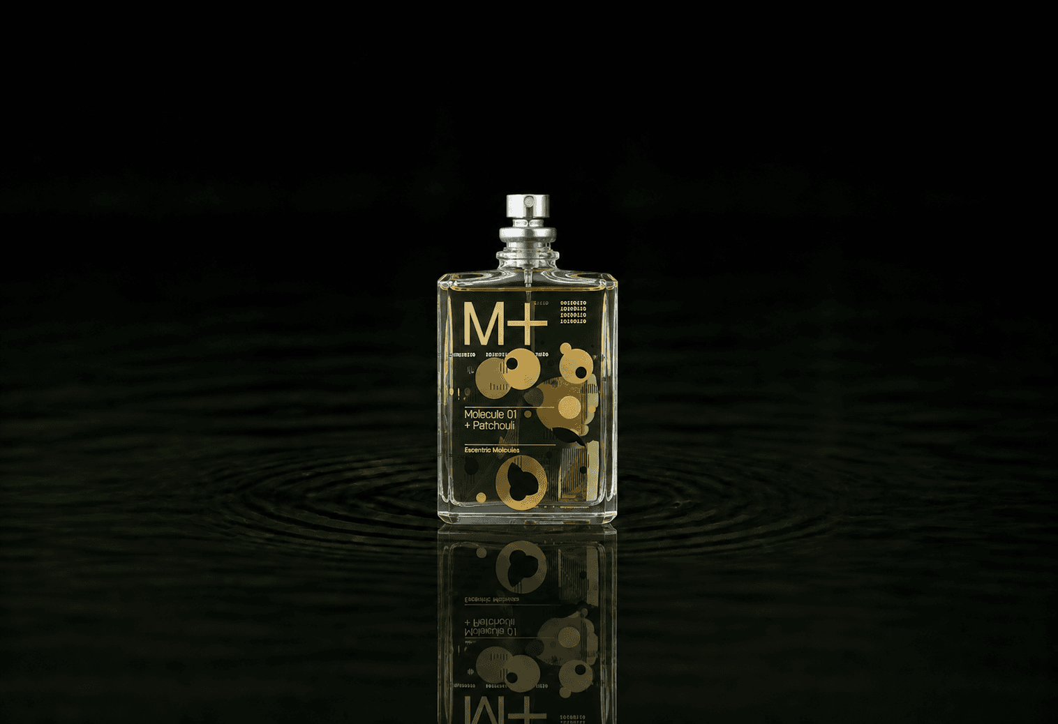 Escentric Molecules Molecule 01 + Patchouli fragrance bottle floating above dark water