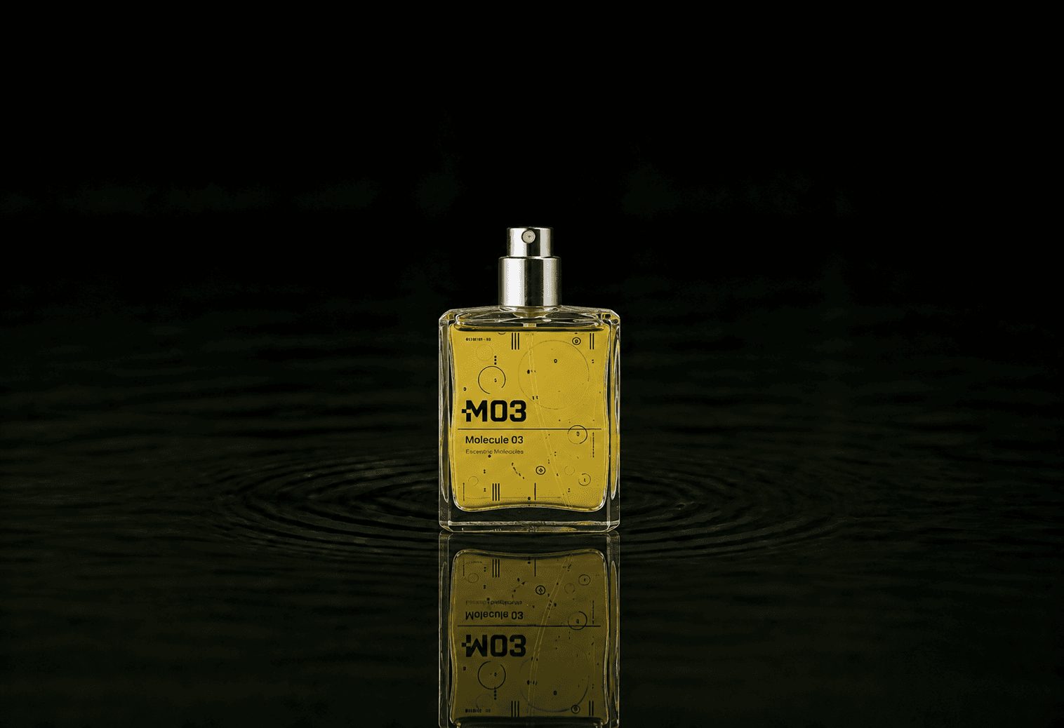 Escentric Molecules Molecule 03 fragrance bottle floating above dark water