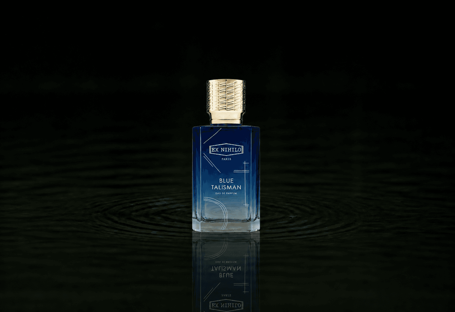 Ex Nihilo Paris Blue Talisman fragrance bottle floating above dark water