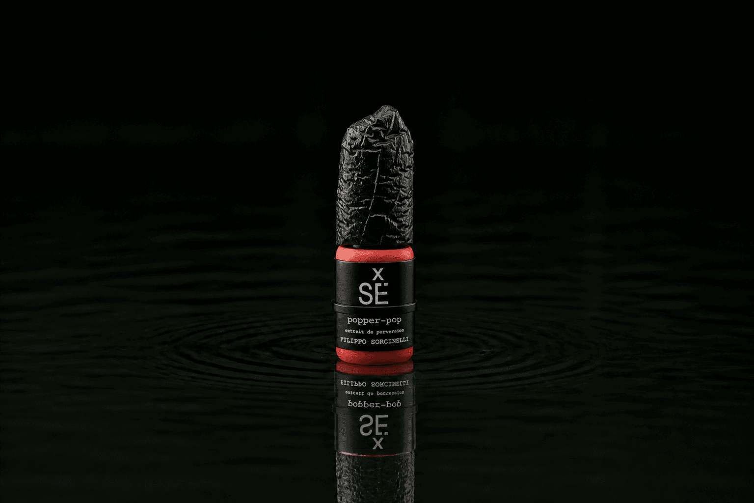 Filippo Sorcinelli Popper Pop fragrance bottle floating above dark water