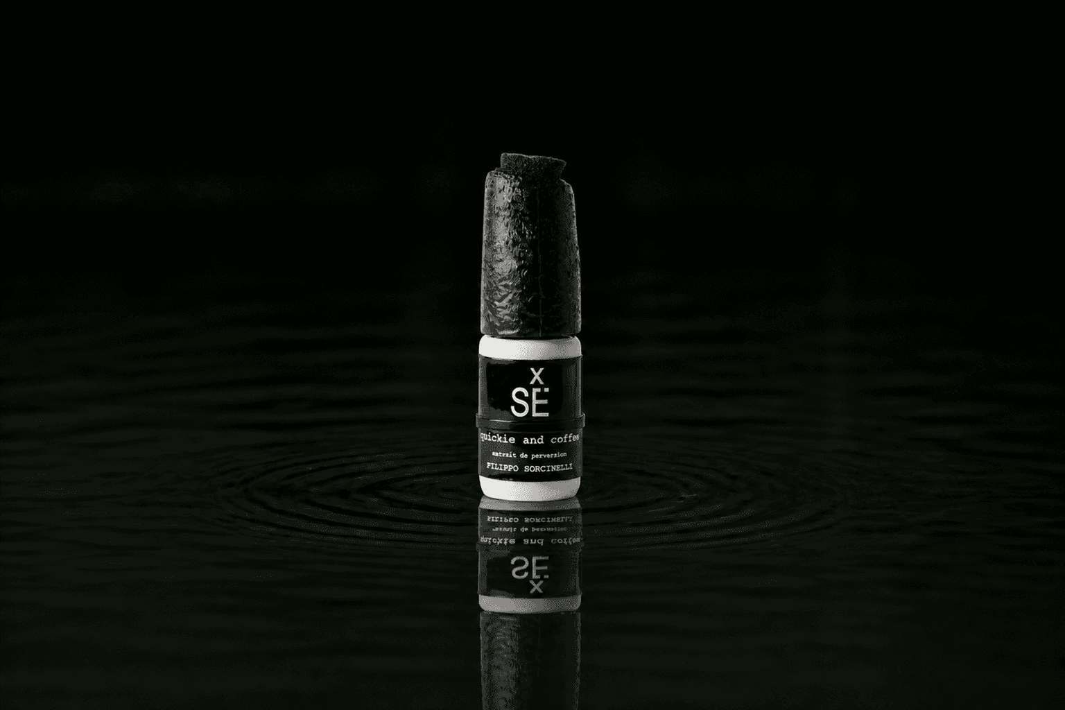 Filippo Sorcinelli Quickie And Coffee fragrance bottle floating above dark water