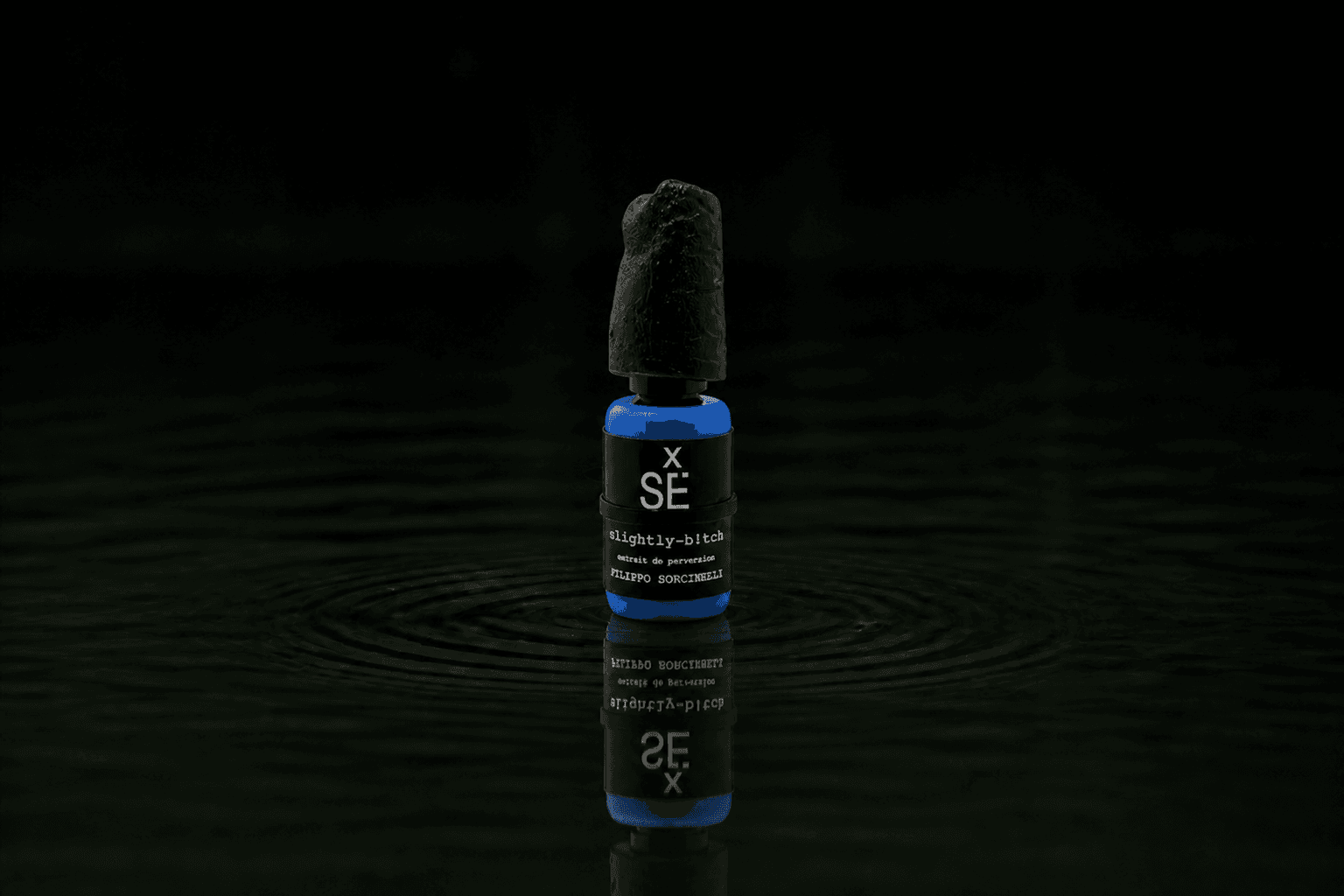 Filippo Sorcinelli Slightly B!tch fragrance bottle floating above dark water