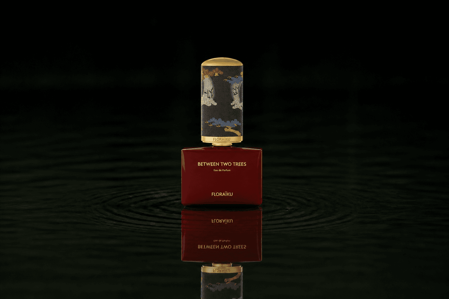Floraiku Between Two Trees - Dark Shadow fragrance bottle floating above dark water