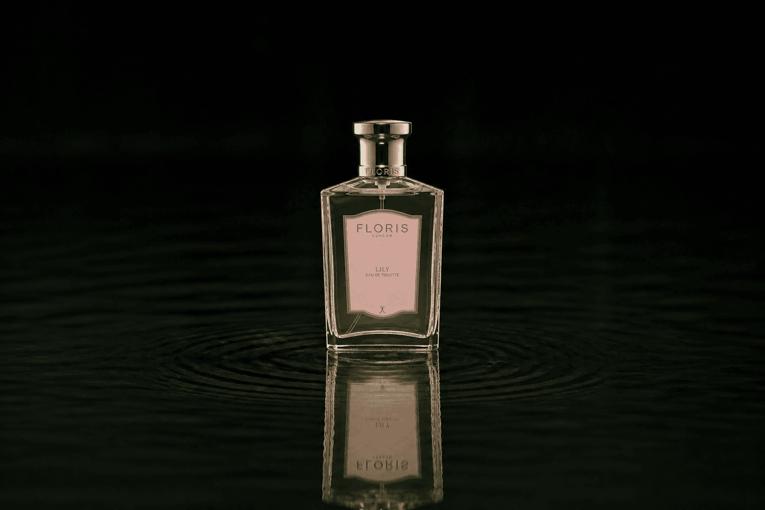 Floris London - Lily fragrance bottle floating above dark water