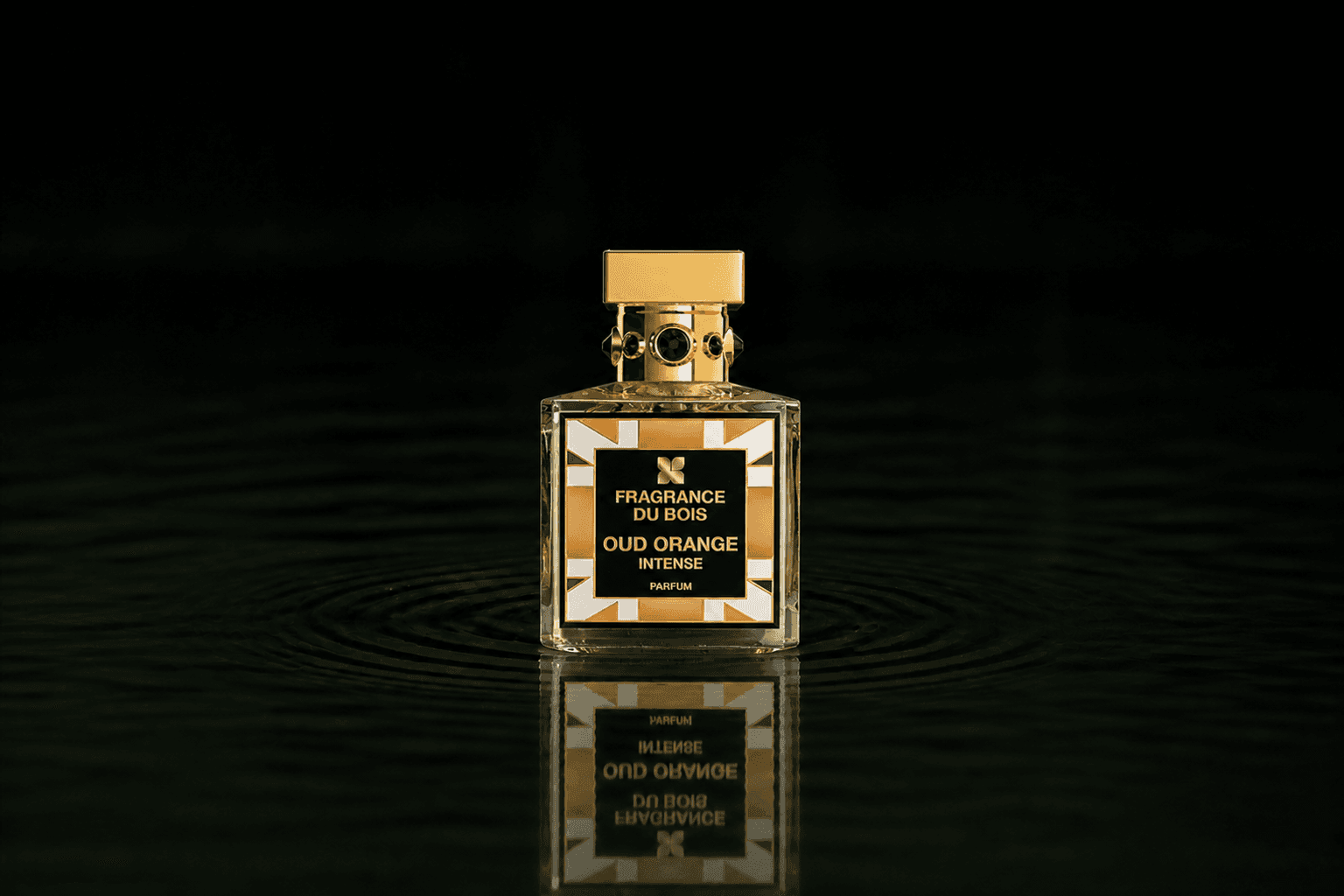 Fragrance Du Bois Oud Orange Intense fragrance bottle floating above dark water