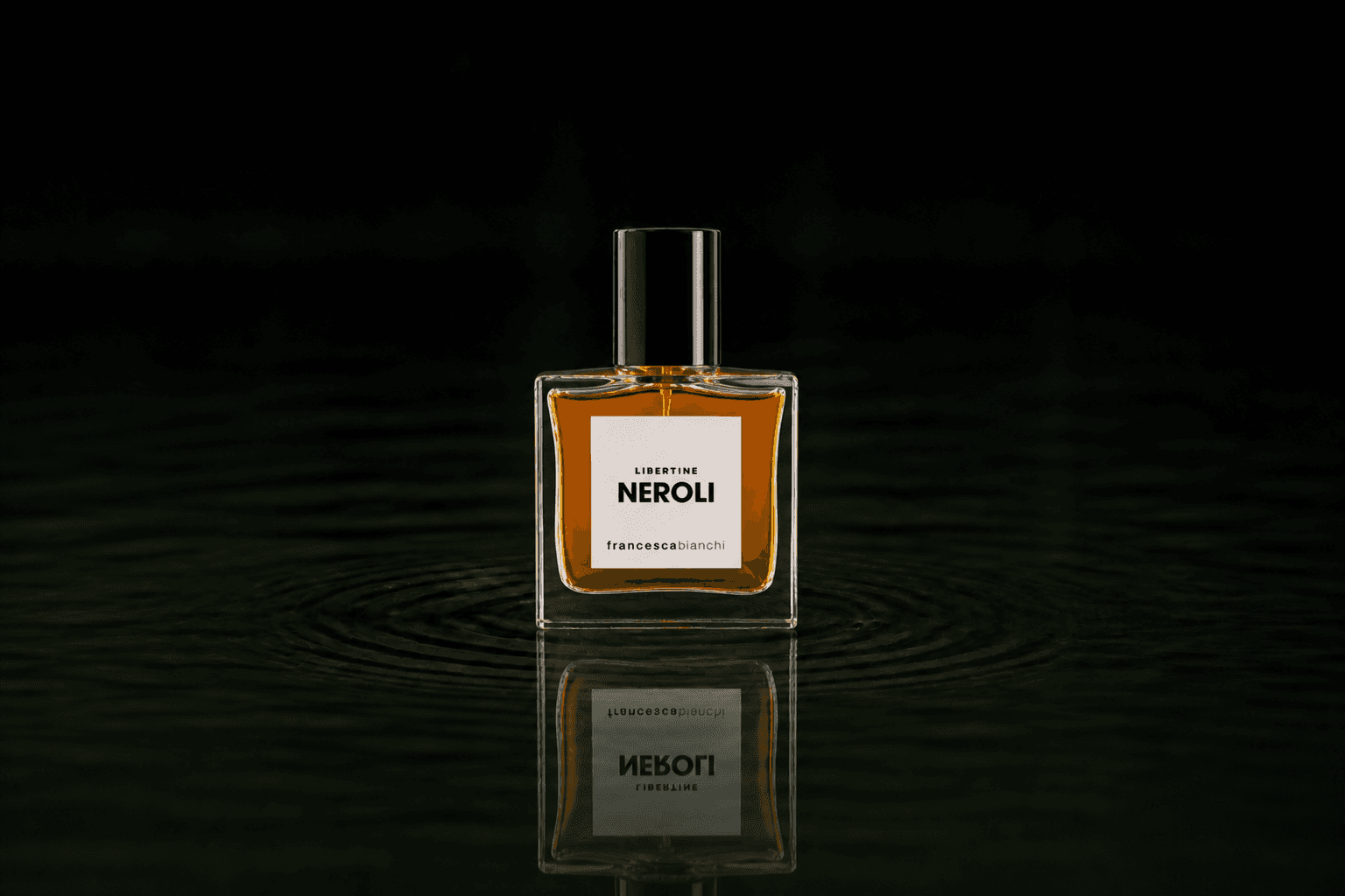Francesca Bianchi Libertine Neroli - Extrait De Perfume fragrance bottle floating above dark water