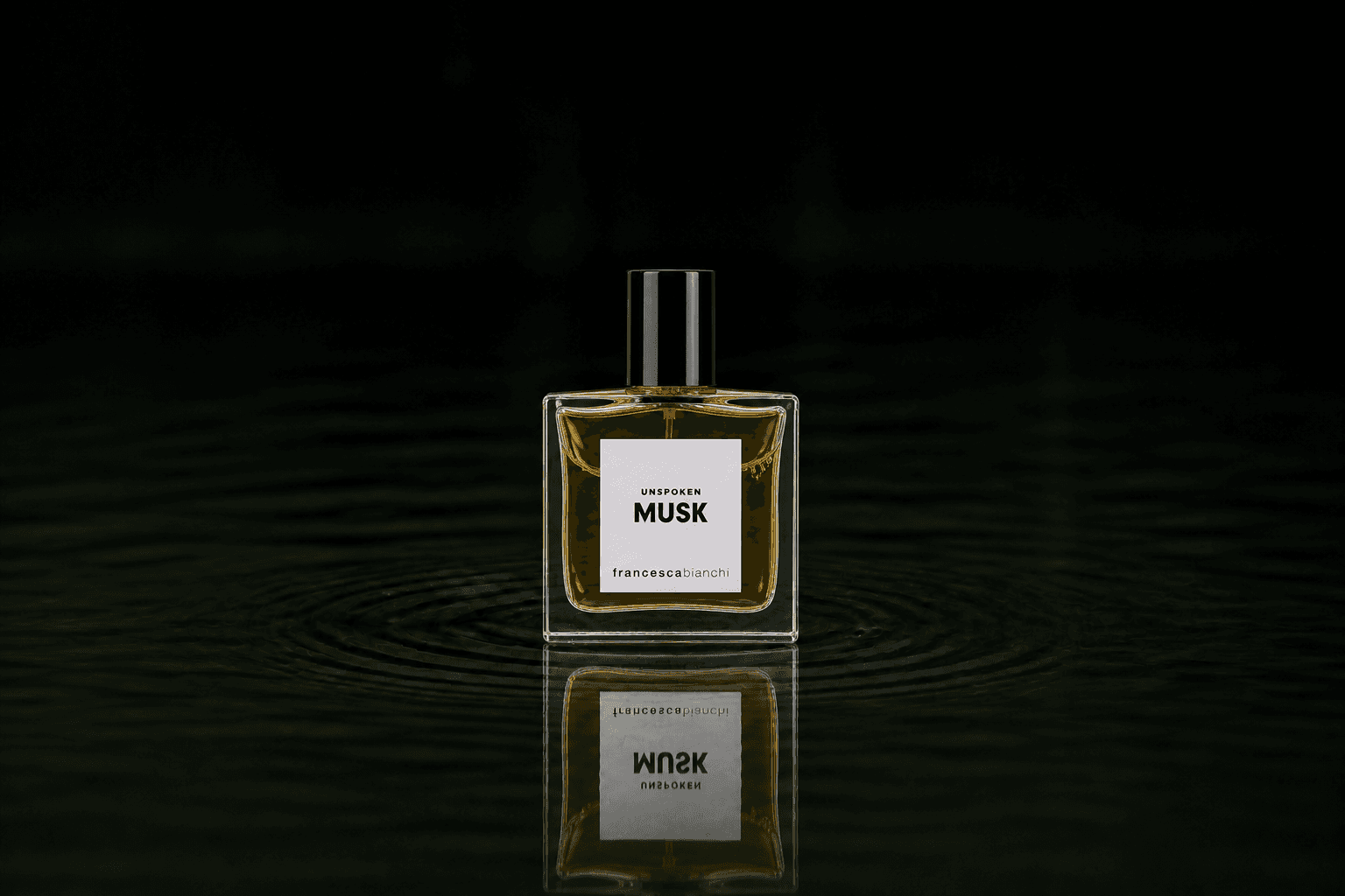 Francesca Bianchi Unspoken Musk fragrance bottle floating above dark water