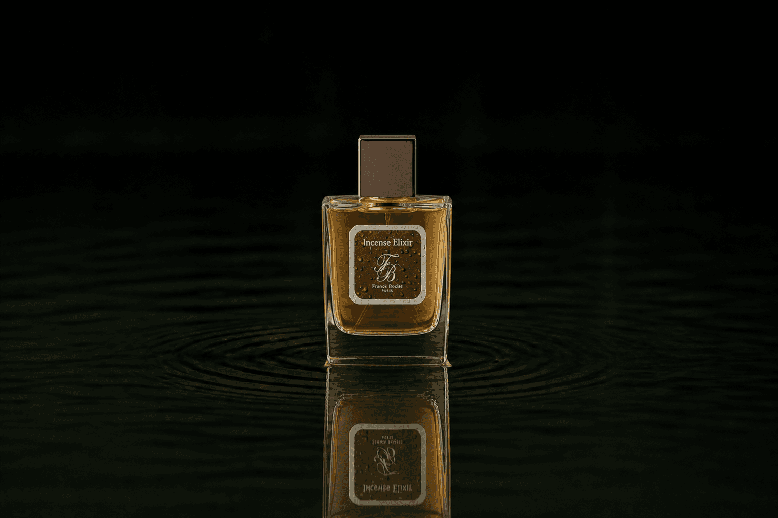 Franck Boclet Incense Elixir fragrance bottle floating above dark water
