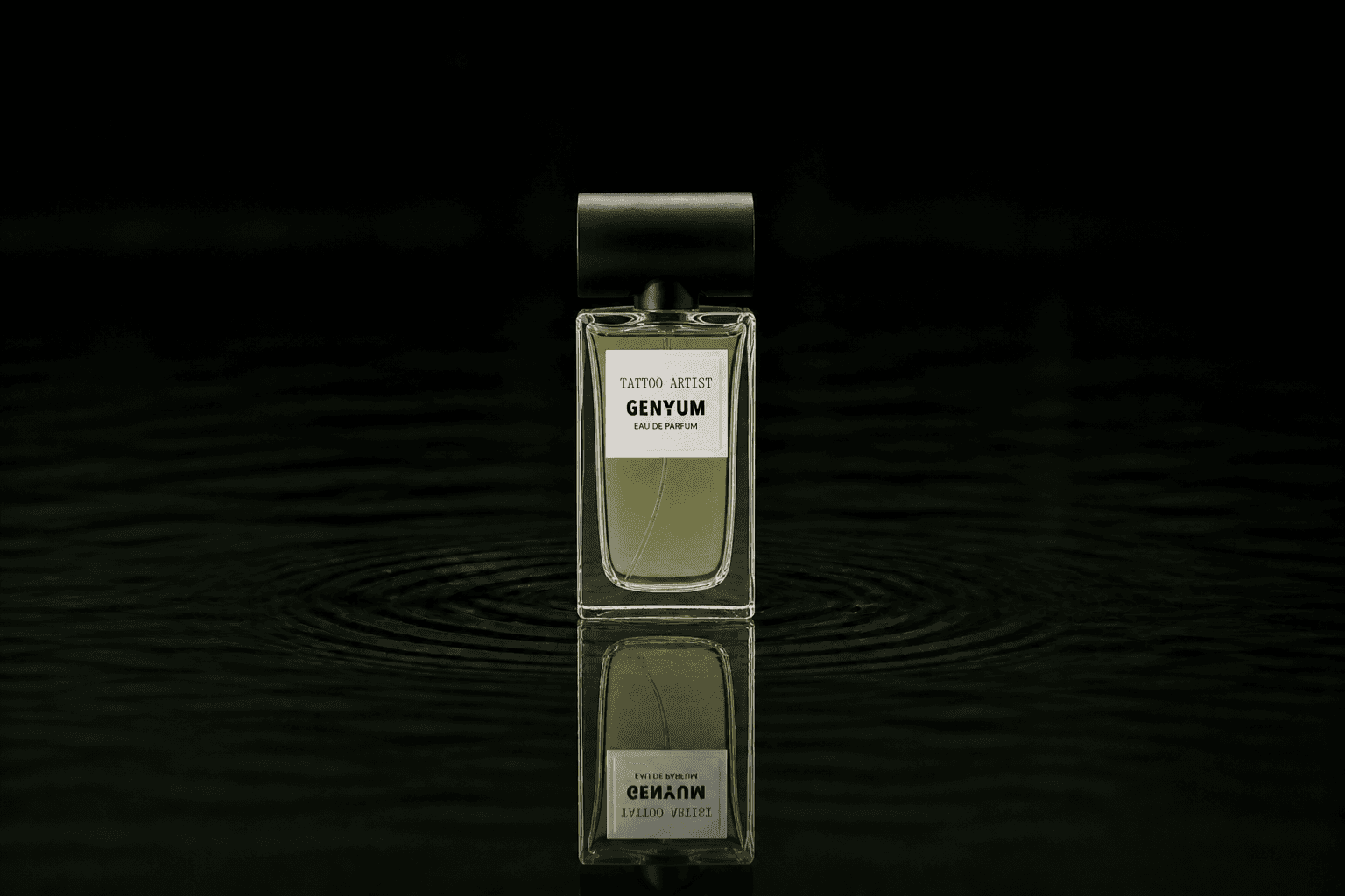Genyum Tattoo Artist fragrance bottle floating above dark water
