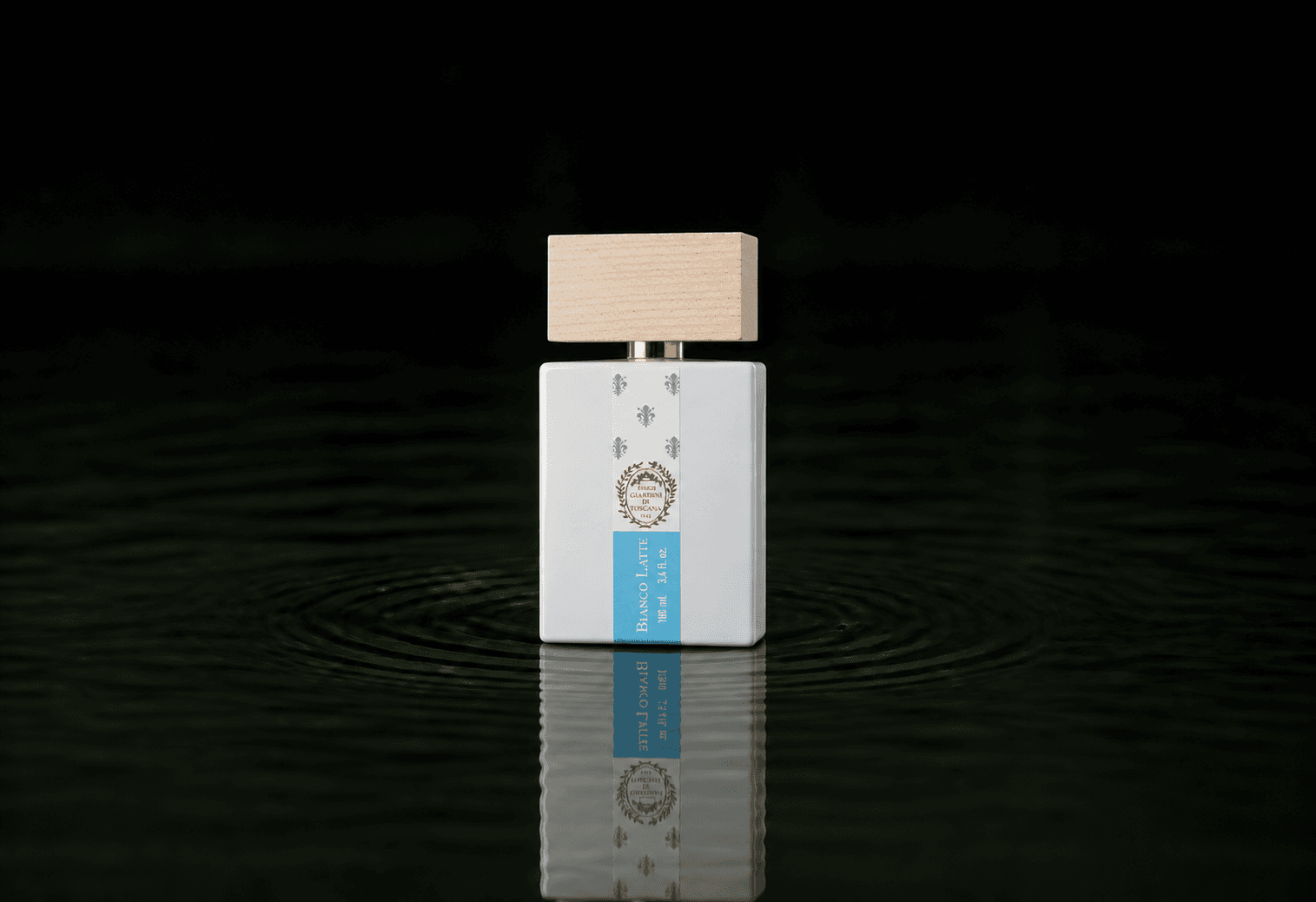 Giardini Di Toscana Bianco Latte fragrance bottle floating above dark water