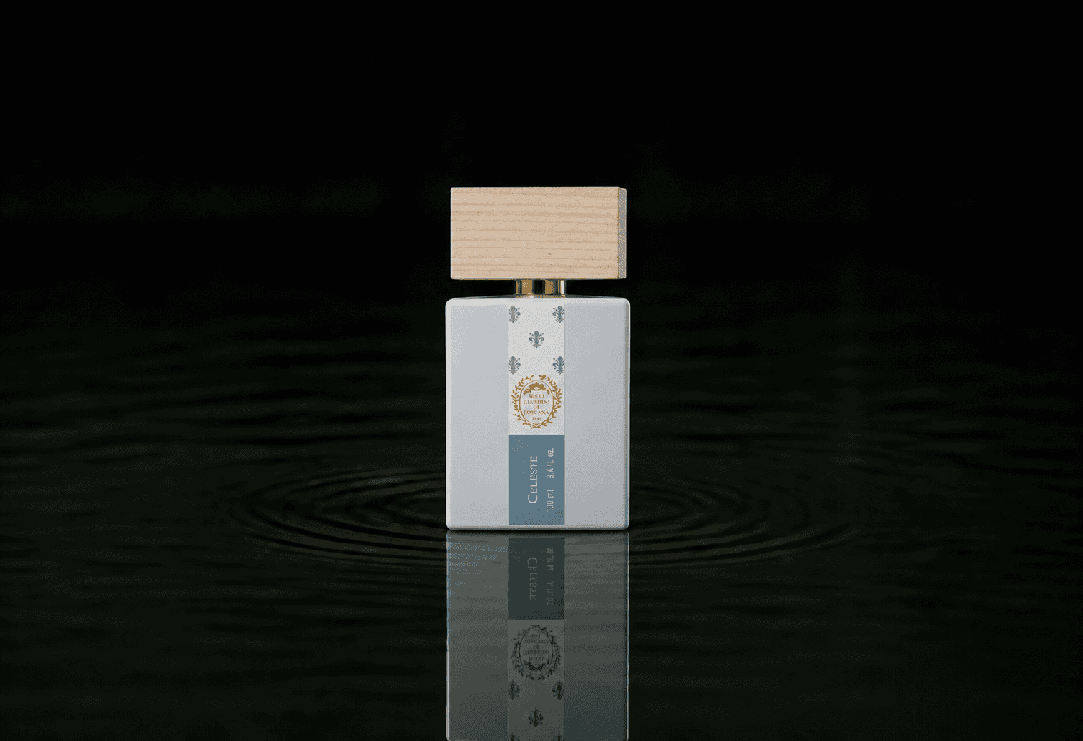 Giardini di Toscana Celeste fragrance bottle floating above dark water