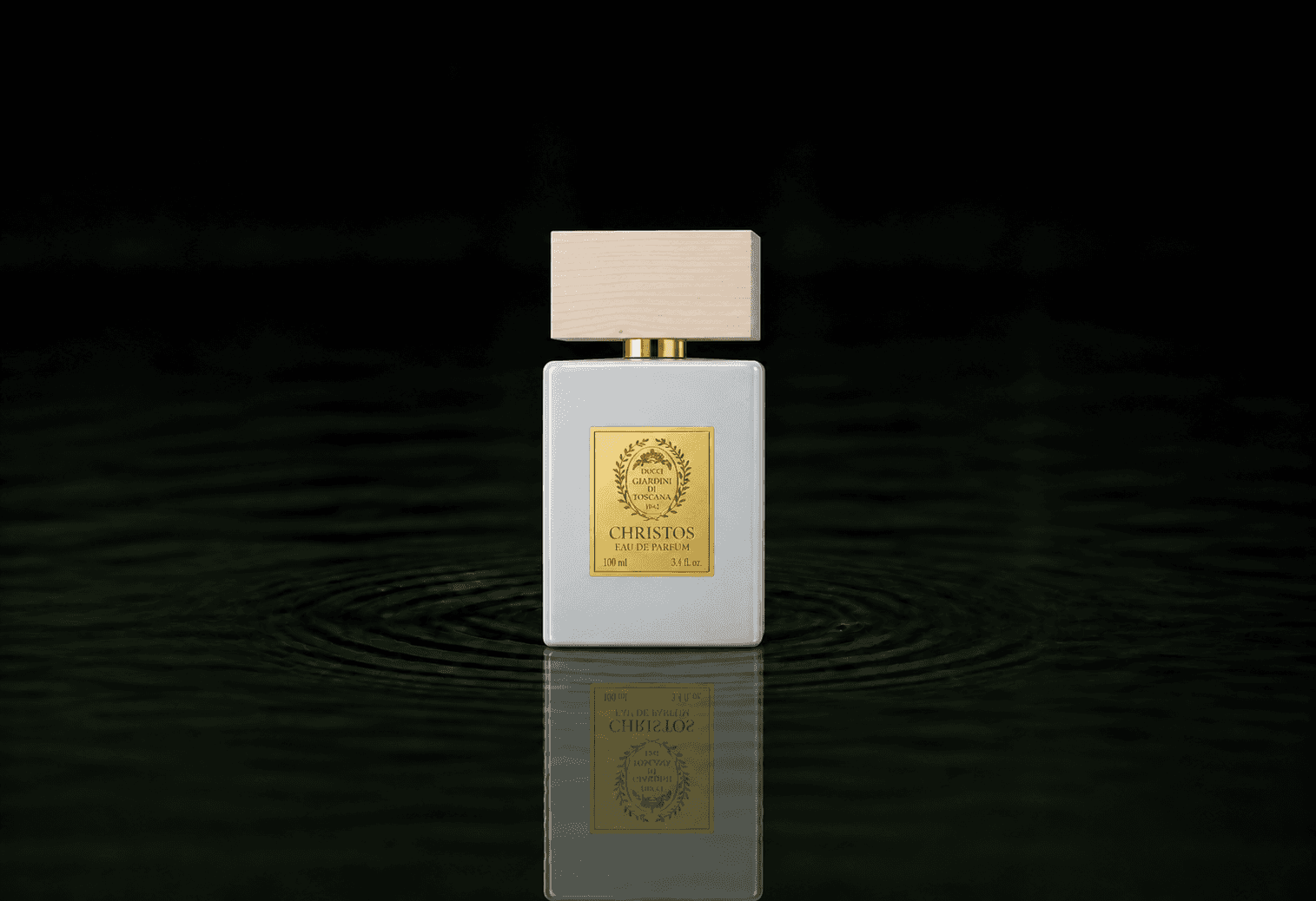 Giardini di Toscana Christos fragrance bottle floating above dark water