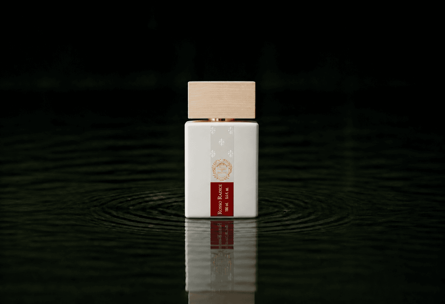 Giardini di Toscana Rosso Radice fragrance bottle floating above dark water
