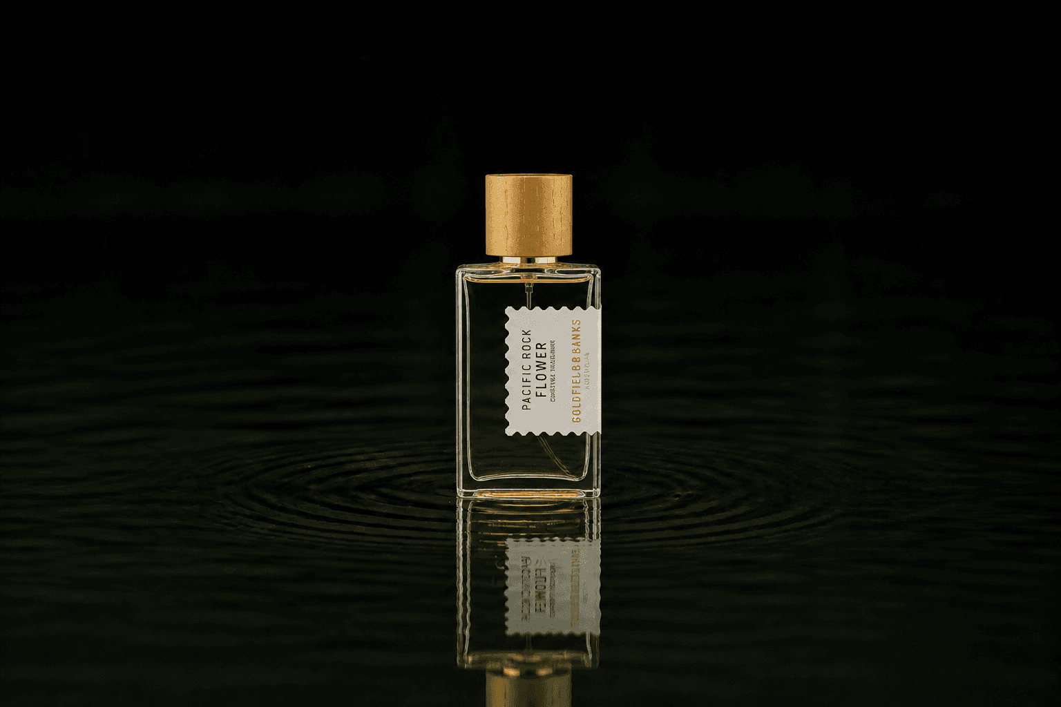 Goldfield & Banks Goldfield and Banks - Pacific Rock Flower fragrance bottle floating above dark water