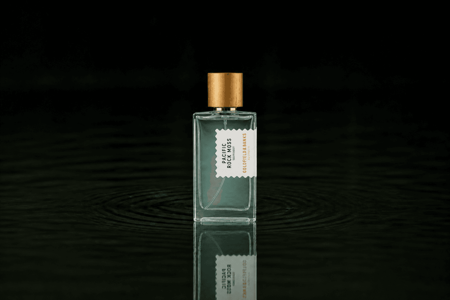 Goldfield & Banks Goldfield and Banks - Pacific Rock Moss fragrance bottle floating above dark water