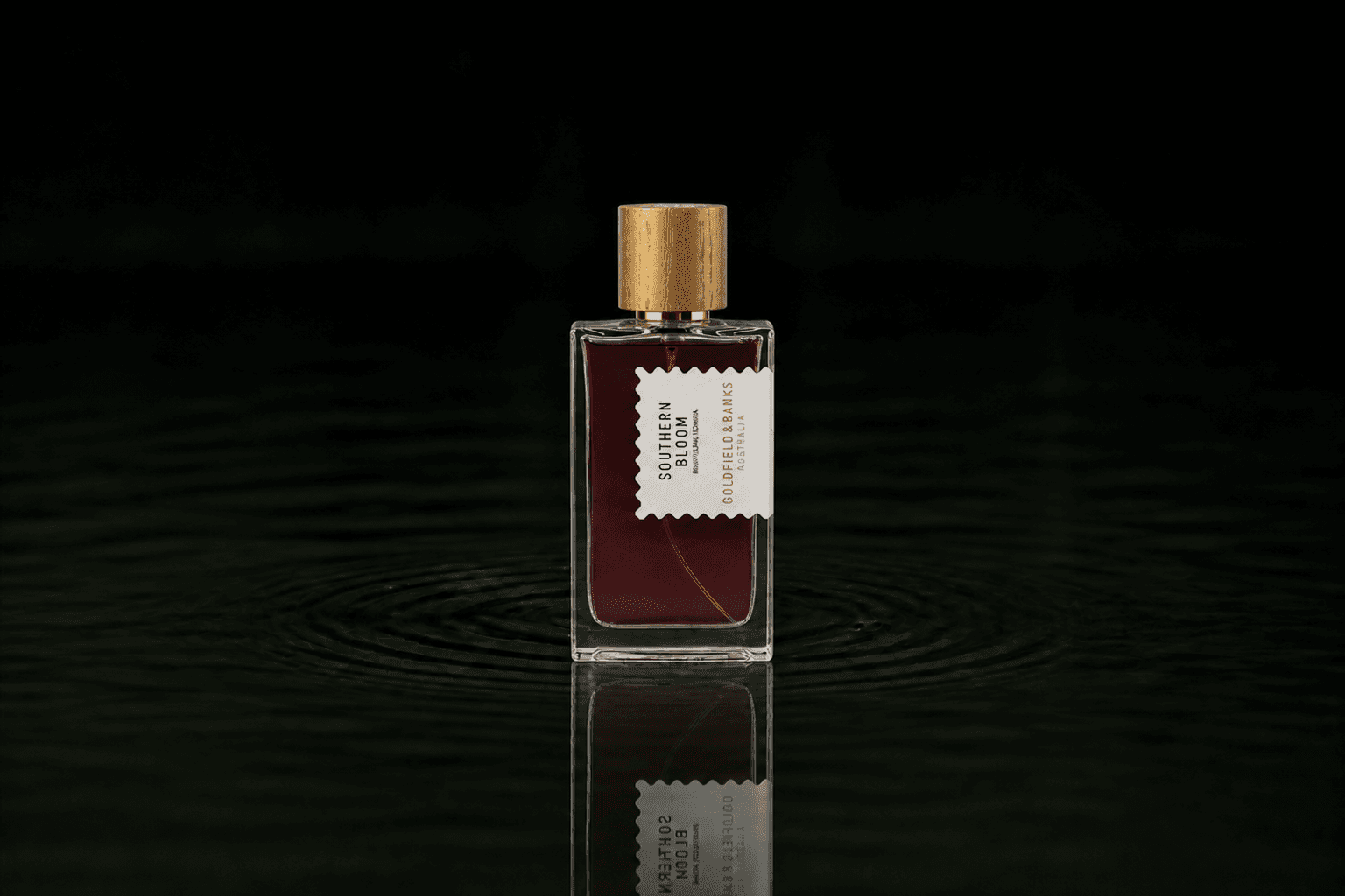 Goldfield & Banks Goldfield and Banks - Southern Bloom fragrance bottle floating above dark water