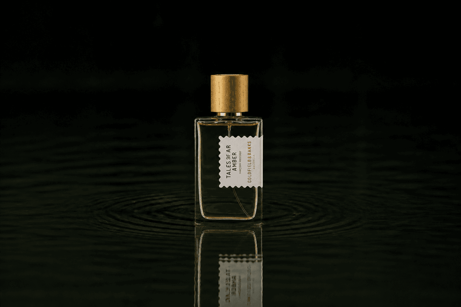 Goldfield & Banks Goldfield and Banks - Tales of Amber fragrance bottle floating above dark water