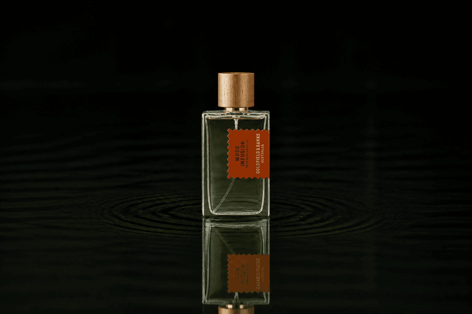 Goldfield & Banks Goldfield and Banks - Wood Infusion fragrance bottle floating above dark water