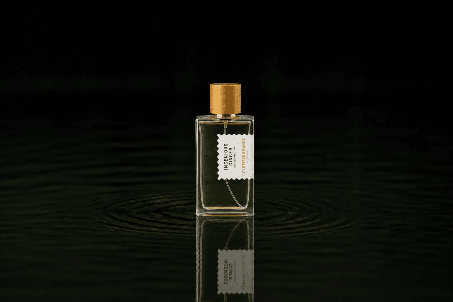 Goldfield & Banks Ingenious Ginger fragrance bottle floating above dark water