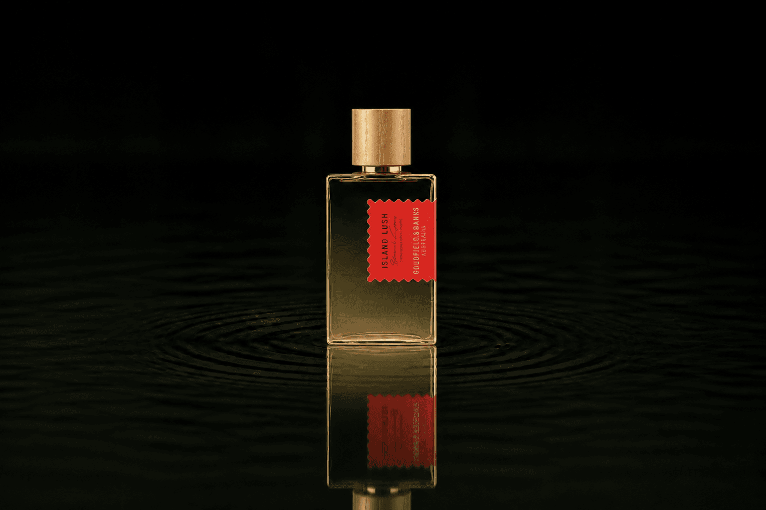 Goldfield & Banks Island Lush - Perfume Concentrate fragrance bottle floating above dark water