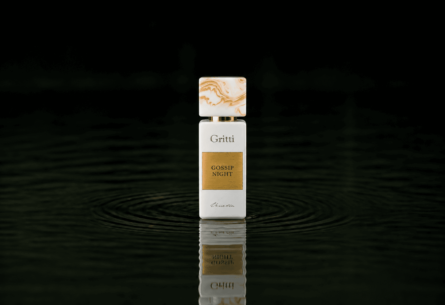 Gritti Gossip Night fragrance bottle floating above dark water