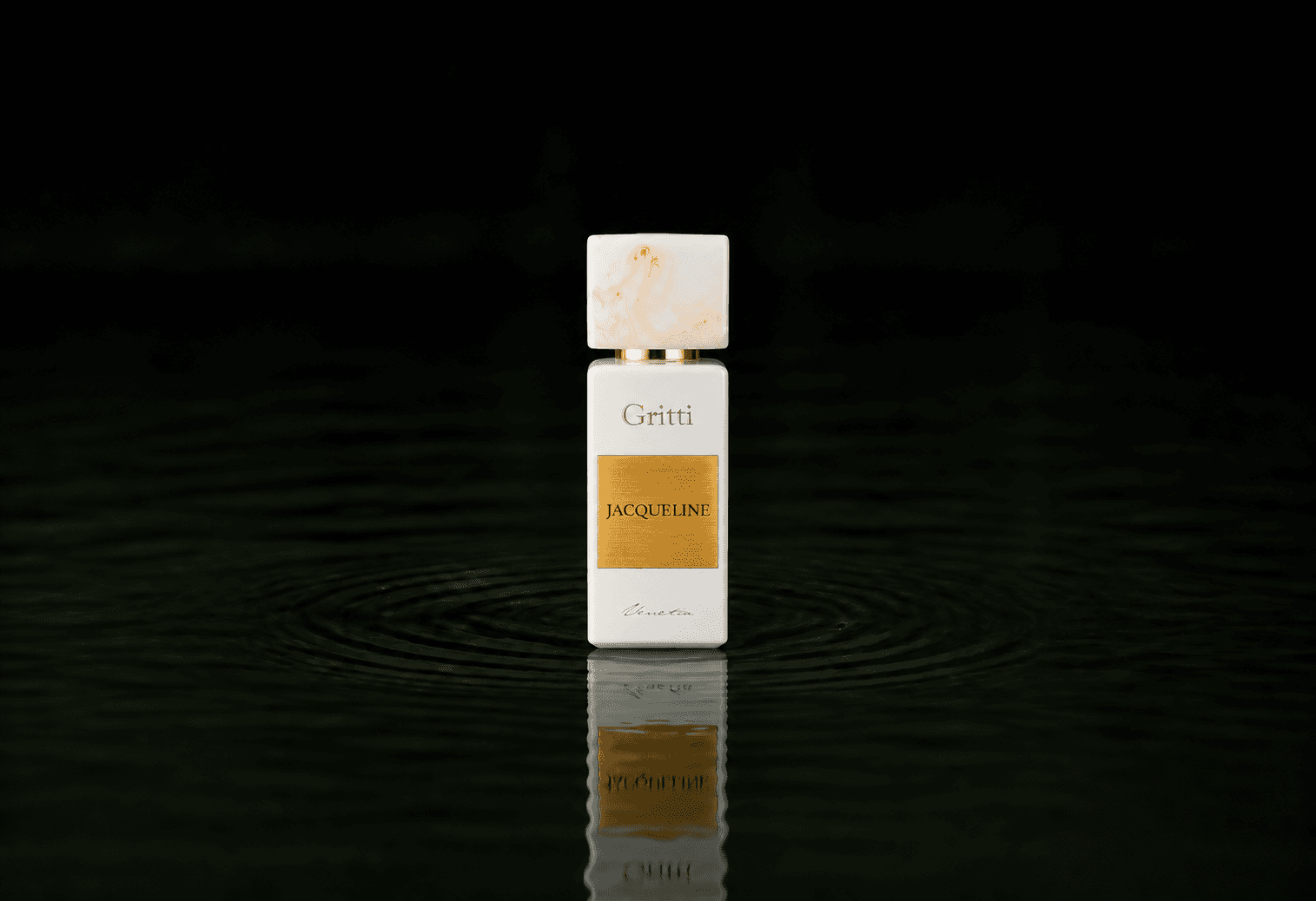 Gritti Jacqueline fragrance bottle floating above dark water