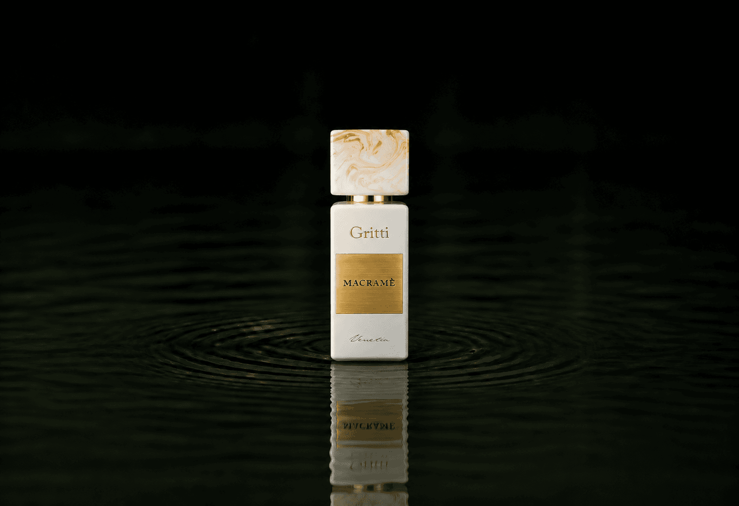 Gritti Macrame fragrance bottle floating above dark water