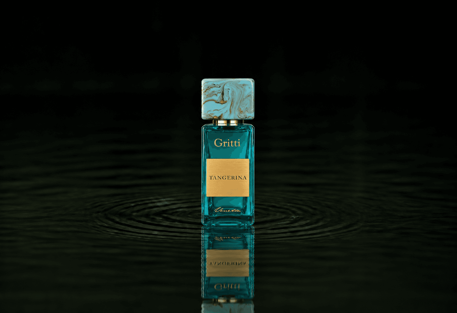 Gritti Tangerina fragrance bottle floating above dark water