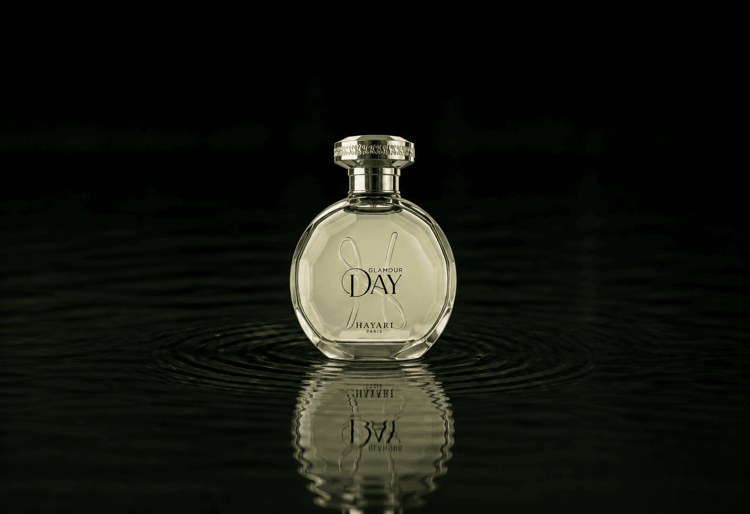 Hayari Glamour Day fragrance bottle floating above dark water