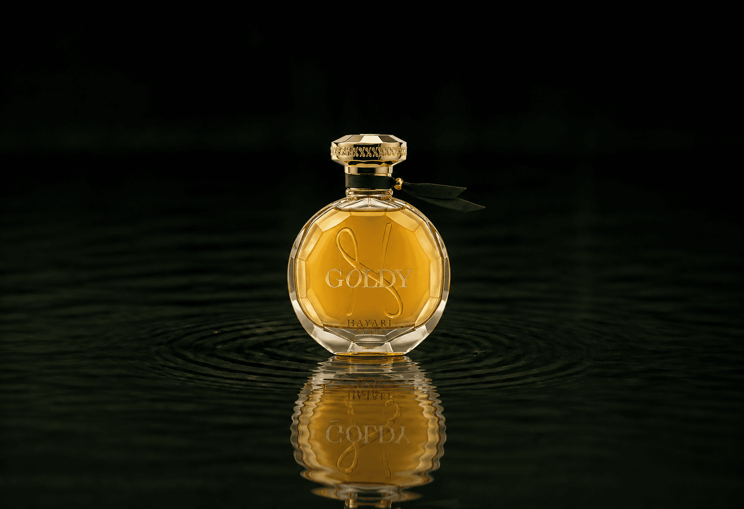 Hayari Goldy fragrance bottle floating above dark water