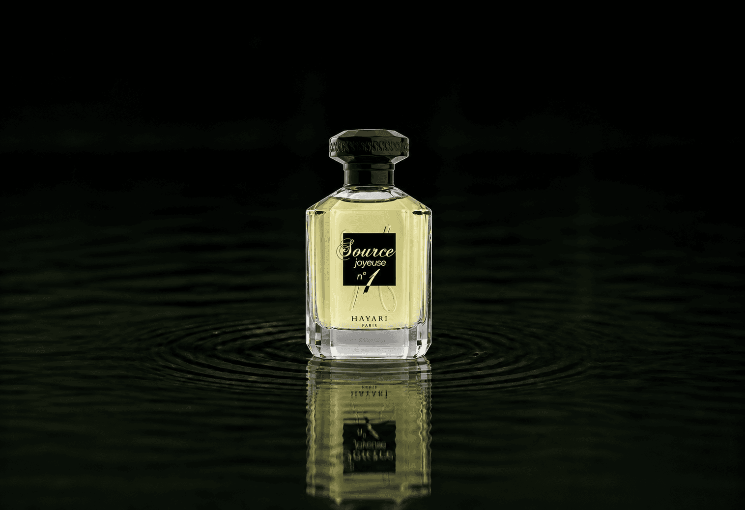 Hayari Source Joyeuse N1 fragrance bottle floating above dark water
