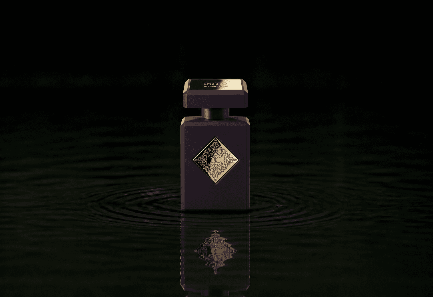 Initio Atomic Rose fragrance bottle floating above dark water