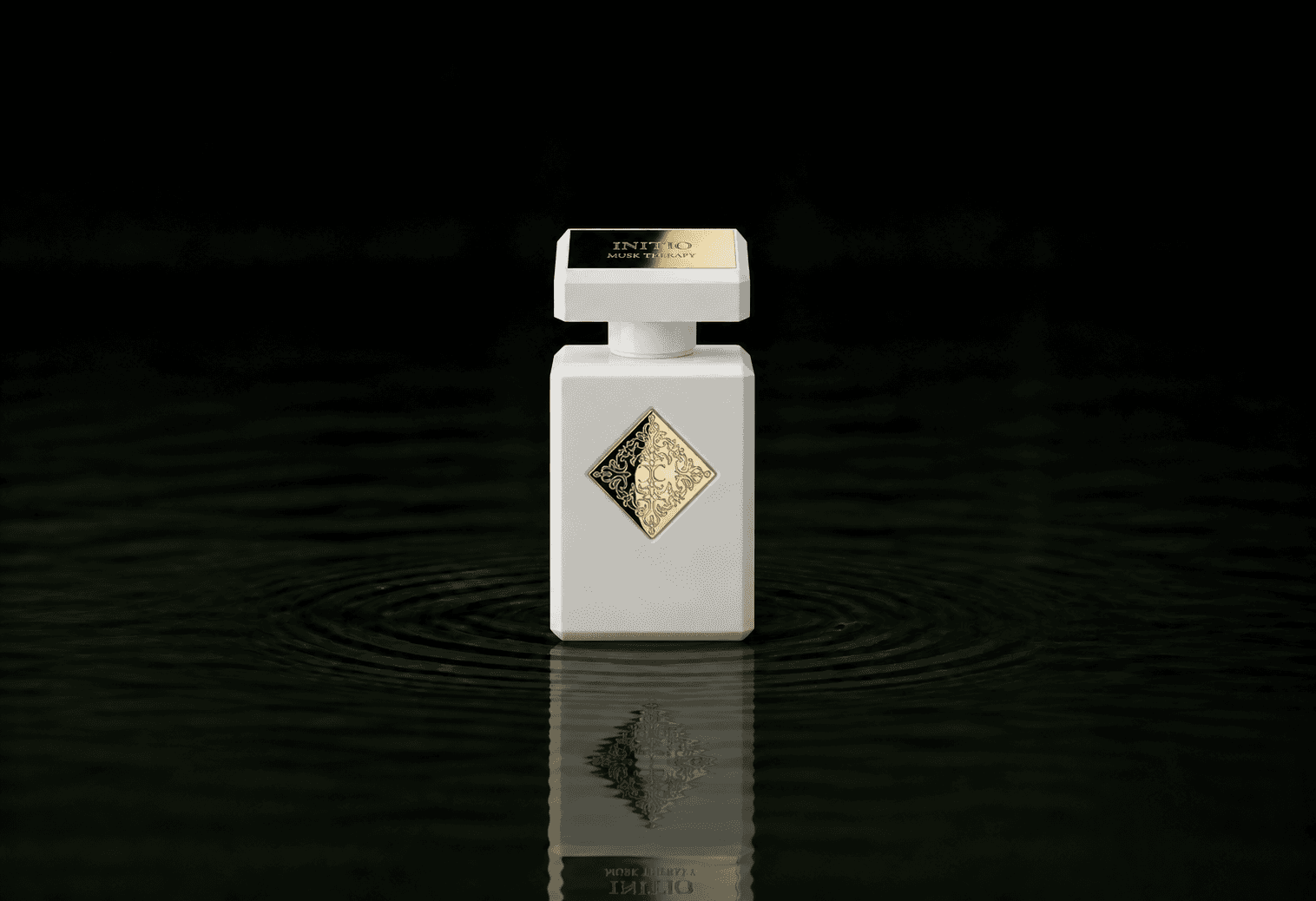 Initio Musk Therapy fragrance bottle floating above dark water