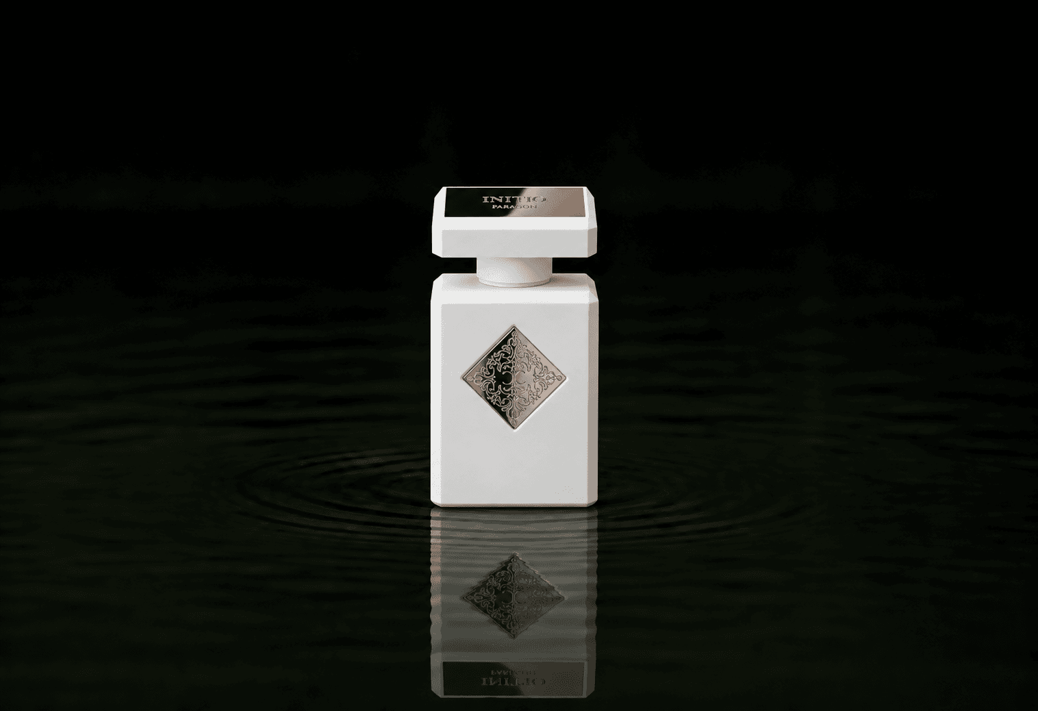 Initio Paragon fragrance bottle floating above dark water
