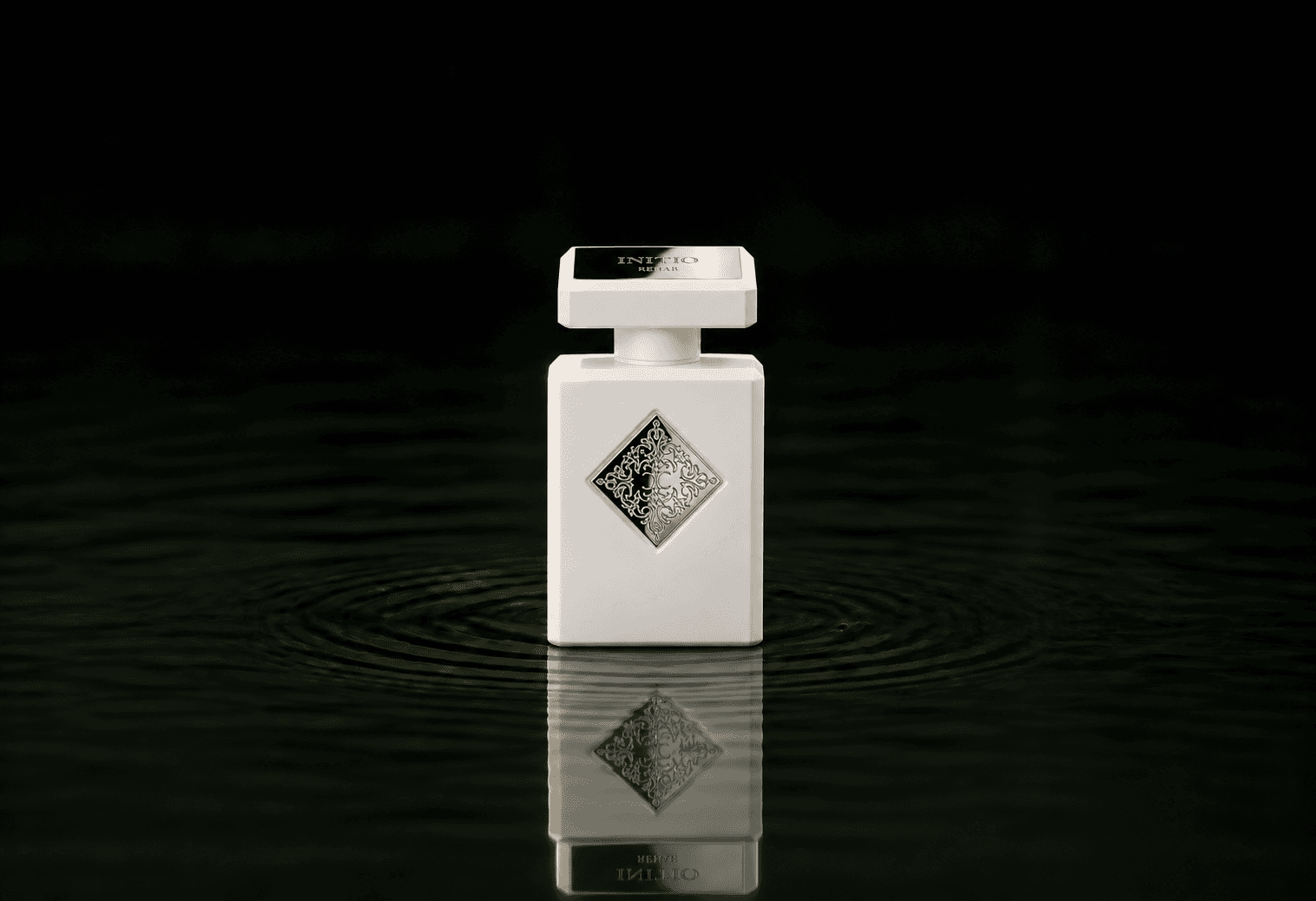 Initio Rehab fragrance bottle floating above dark water