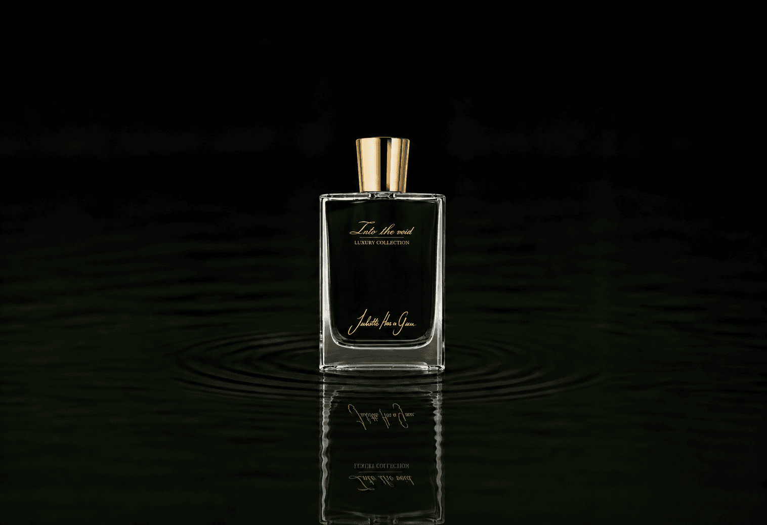 Juliette Has A Gun In To The Void fragrance bottle floating above dark water