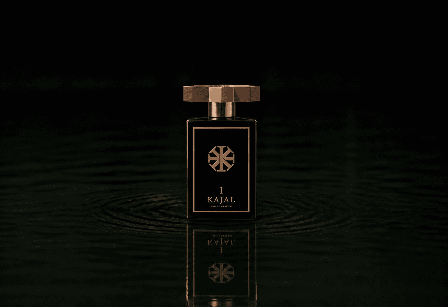 Kajal Homme I fragrance bottle floating above dark water