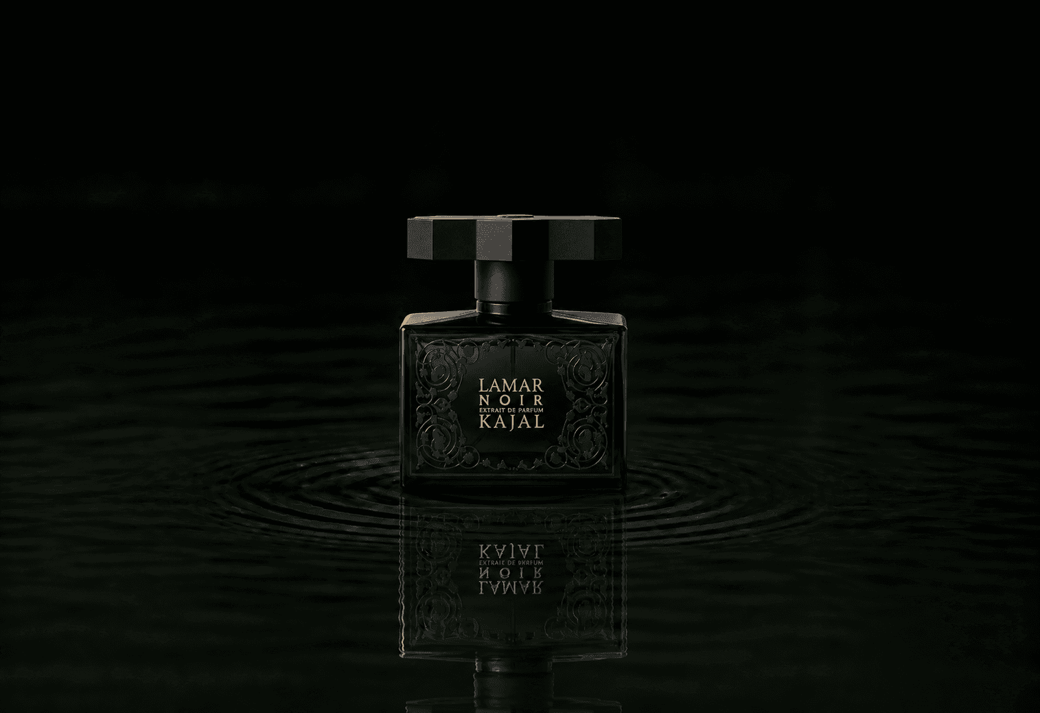 Kajal Lamar Noir fragrance bottle floating above dark water